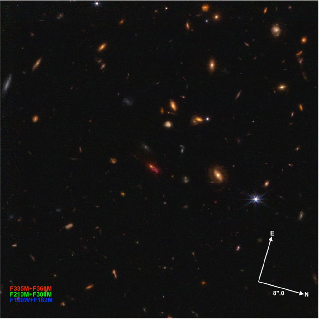 This image shows the TNJ1338-1942 protocluster, the most distant known protocluster. It contains a luminous, steep-spectrum radio source. The radio source is an active galactic nucleus, and a future JWST observing program will study it in more detail. The radio source is the irregular orange object in the center. Image Credit: STScI/Windhorst et al. 2023. 