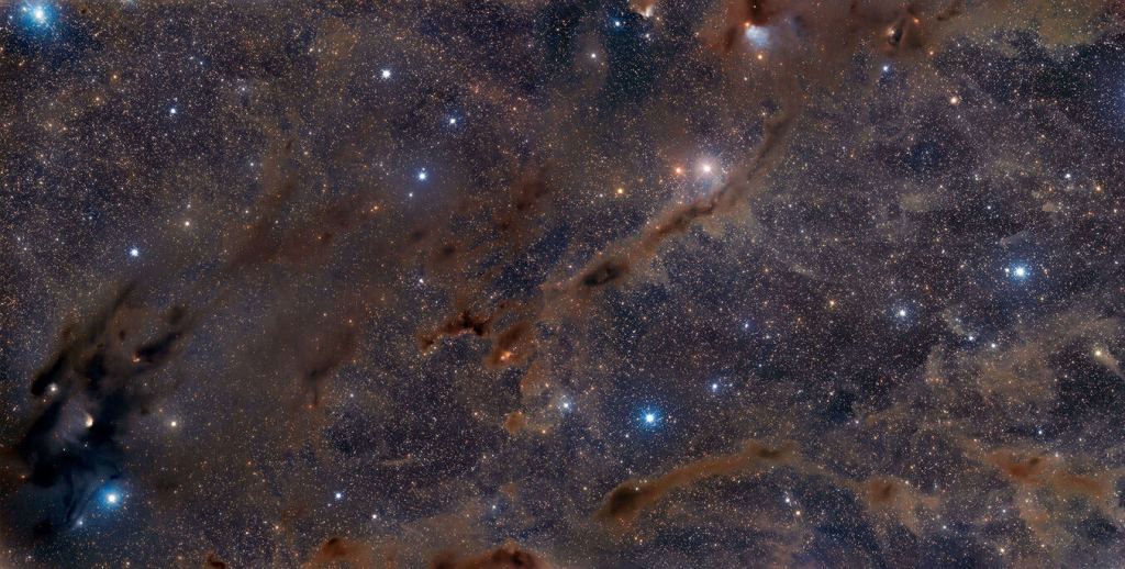 This is a two-panel mosaic of part of the Taurus Giant Molecular Cloud, the nearest active star-forming region to Earth. The darkest regions are where stars are being born. Inside these vast clouds, complex chemicals are also forming. Image Credit: Adam Block /Steward Observatory/University of Arizona