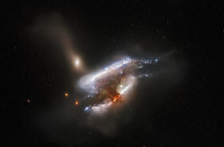 IC 2431 is another triple galaxy merger almost 700 million light-years away. The tidal distortions are obvious in this image, and the merger is also triggering star formation. Image Credit: ESA/Hubble & NASA, W. Keel, Dark Energy Survey, DOE, FNAL, DECam, CTIO, NOIRLab/NSF/AURA, SDSS
Acknowledgement: J. Schmidt