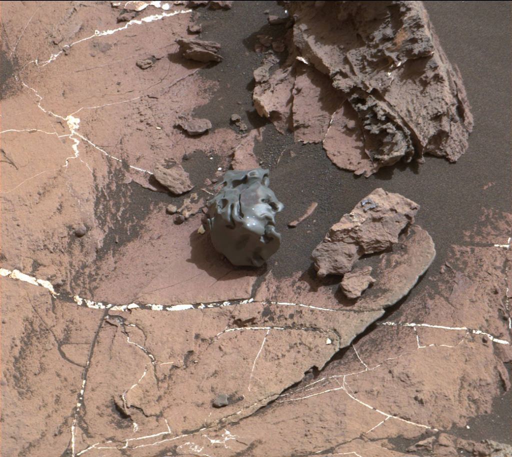 The dark, smooth-surfaced object at the center of this Oct. 30, 2016, image from the Mast Camera (Mastcam) on NASA's Curiosity Mars rover was examined with laser pulses and confirmed to be an iron-nickel meteorite. Its surface is also marked with regmaglypts. Image Credit: NASA/JPL-Caltech/MSSS