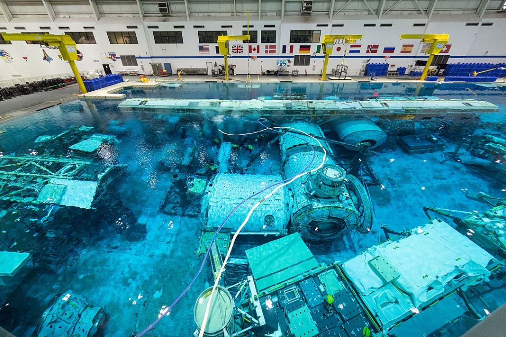 The Neutral Buoyancy Laboratory (NBL) is an astronaut training facility and neutral buoyancy pool operated by NASA and located at the Sonny Carter Training Facility near the Johnson Space Center in Houston, Texas. It holds 23 million litres (6.2 million gallons) of water and contains mock-ups of the ISS modules. Image Credit: By NASA Goddard Photo and Video - https://www.flickr.com/photos/24662369@N07/49565807881/, CC BY 2.0, https://commons.wikimedia.org/w/index.php?curid=87326373