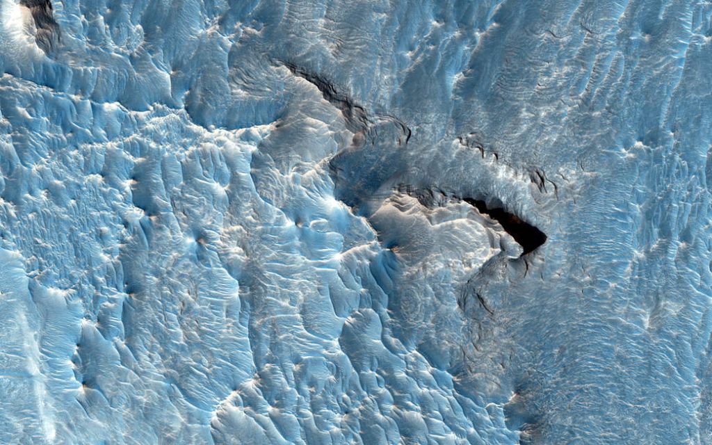 This is a High-Resolution Imaging Science Experiment (HiRISE) image of an LTD in Aureum Chaos, another part of Valles Marineris. The top of the LTD appears rough, while the surroundings are smooth. Image Credit: NASA/JPL/University of Arizona