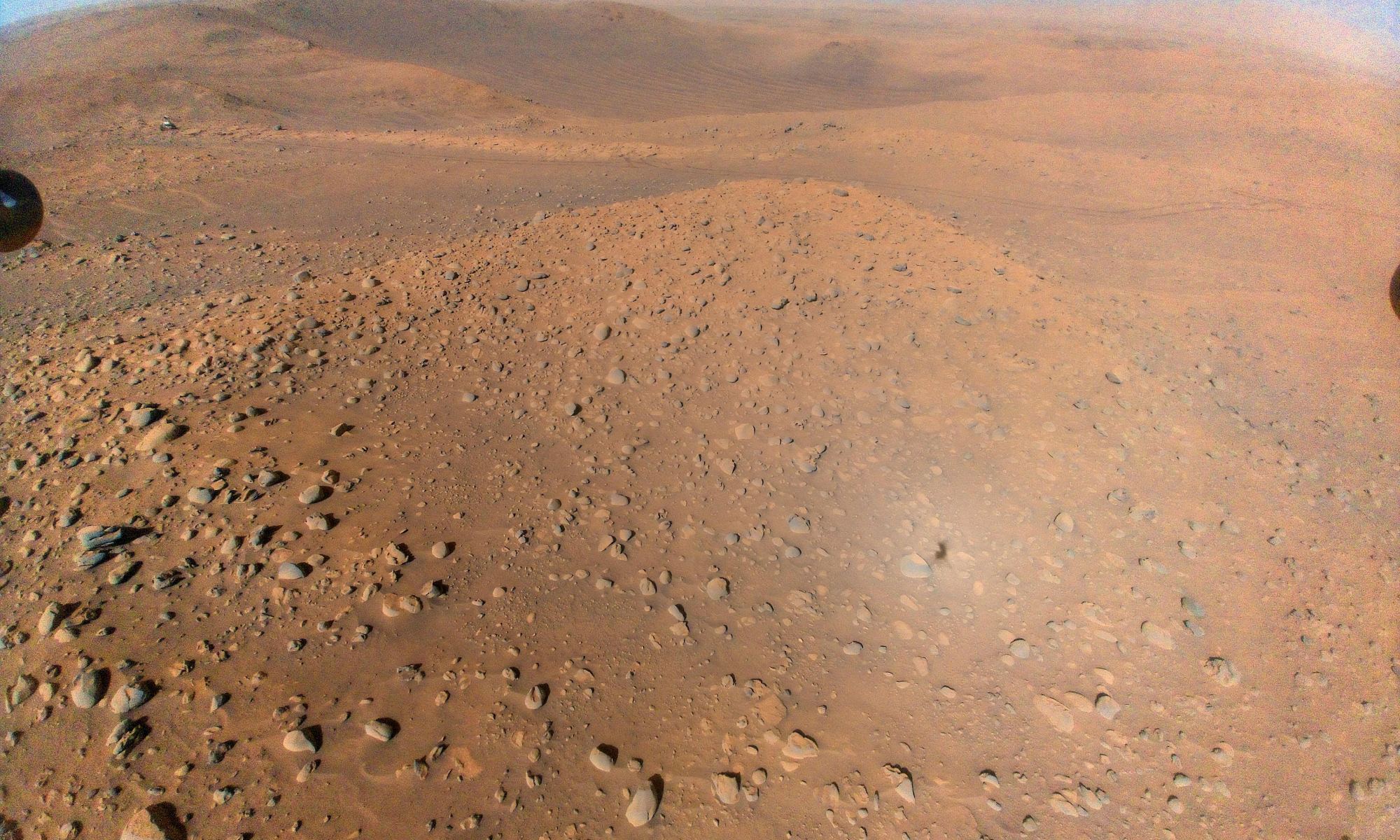 This image of NASA's Perseverance Mars rover at the rim of Belva Crater was taken by the agency's Ingenuity Mars Helicopter during the rotorcraft's 51st flight on April 22, 2023, the 772nd Martian day, or sol, of the rover's mission. At the time the image was taken, the helicopter was at an altitude of about 40 feet (12 meters).