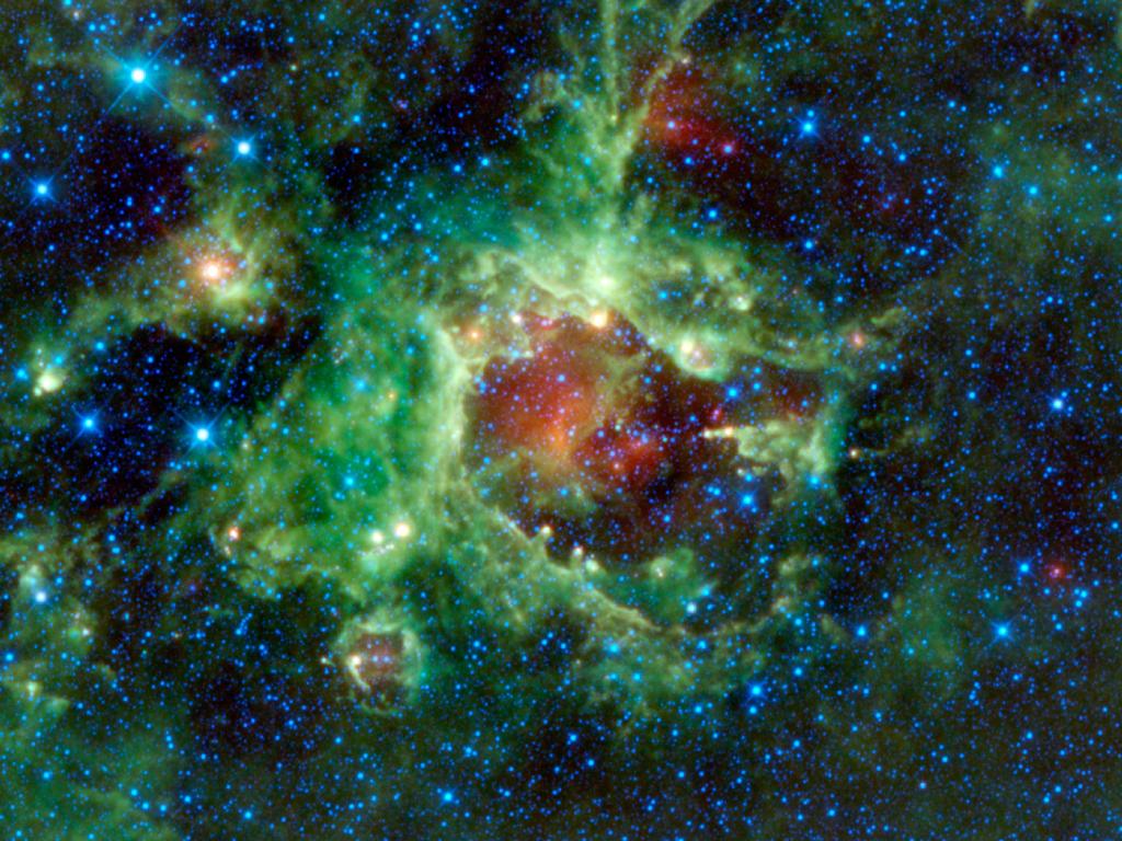 NASA's WISE (Wide-field Infrared Survey Explorer) captured this infrared image of Sh2-284. It clearly shows how the stars in Dolidze-25 are carving out a bubble in the middle of the HII region. Image Credit: NASA/JPL-Caltech/UCLA 
