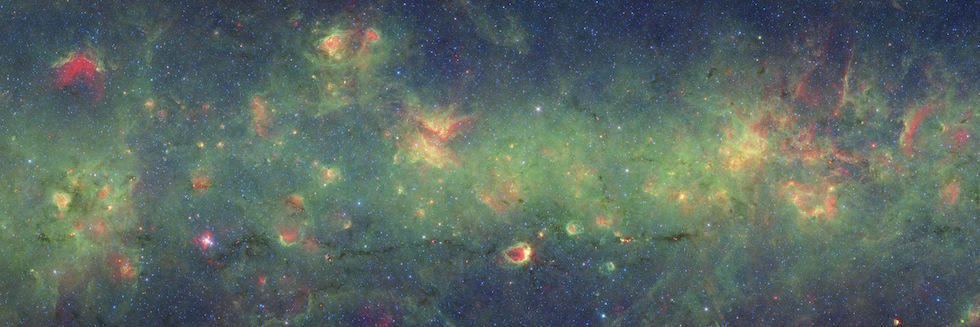 A three-color composite of a portion of the Nessie Nebula that shows infrared observations from two Spitzer instruments. The bright red circular region in the center is the site of triggered star formation. Courtesy NASA/JPL.