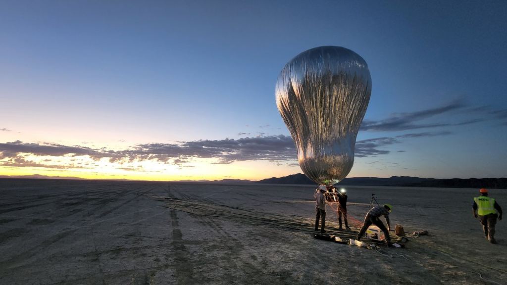 A prototype aerial robotic balloon, or aerobot, is readied for a sunrise test flight at Black Rock Desert, Nevada, in July 2022, by team members from JPL and Near Space Corporation. The aerobot successfully completed two flights, demonstrating controlled altitude flight. Credit: NASA/JPL-Caltech