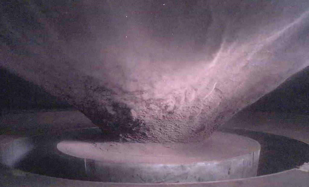 This is the side view of the ejecta curtain created during a hypervelocity impact experiment at the NASA Ames Vertical Gun Range. The researchers performed impact gun experiments on the same type of organics found on Ceres. While other studies have examined the effect of impacts on organic chemicals, this is the first time it's been done with the same ones found on the dwarf planet. Image Credit: NASA / Johns Hopkins University Applied Physics Laboratory.