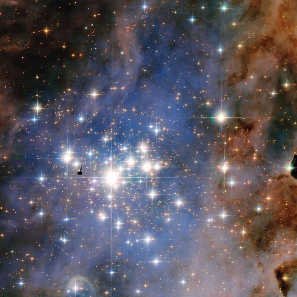 This NASA/ESA Hubble Space Telescope image features the star cluster Trumpler 14. One of the largest gatherings of hot, massive and bright stars in the Milky Way, this cluster houses some of the most luminous stars in our entire galaxy. Radiation from those stars is eating away at nearby pillars in the Carina Nebula. Courtesy NASA/ESA/STScI.