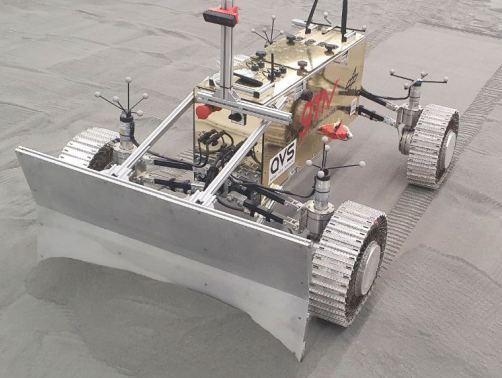 The new modular lunar rover design will have to move lunar regolith as part of building the Astrophysics Lunar Observatory. This image shows the test rover with its bulldozer blade attached during testing. Image Credit: ESA
