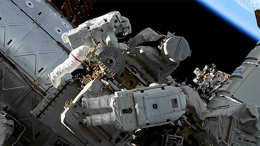 NASA astronauts Jasmin Moghbeli (top) and Loral O’Hara (bottom) team up during their first spacewalk for maintenance on the outside of the space station. Credit: NASA TV