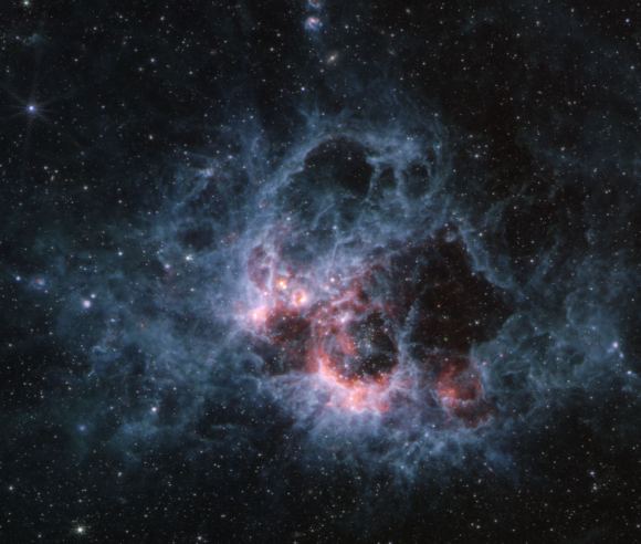 The view of NGC 604 from JWST's MIRI instrument. Notice the difference in view from NIRCam. Each part of the infrared spectrum reveals different features in the clouds of gas and dust. Credit: NASA, ESA, CSA, STScI